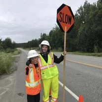 construction people holding sign at roadway construction