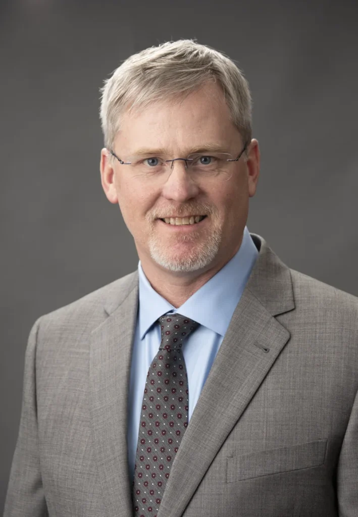 john sommer tutka headshot in suit